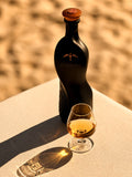 The Curatist Panama Edition beside a neat pour in afternoon light