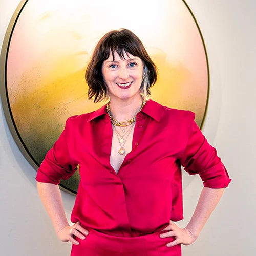 Kate Mayer in front of one of her circular paintings